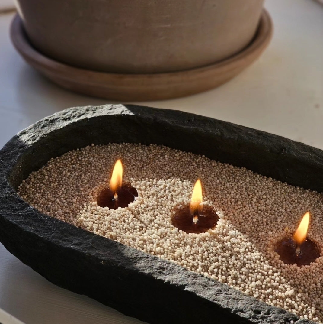 Three-wick Hom33 pearled candle in a black stone bowl, styled with a houseplant for modern home decor.