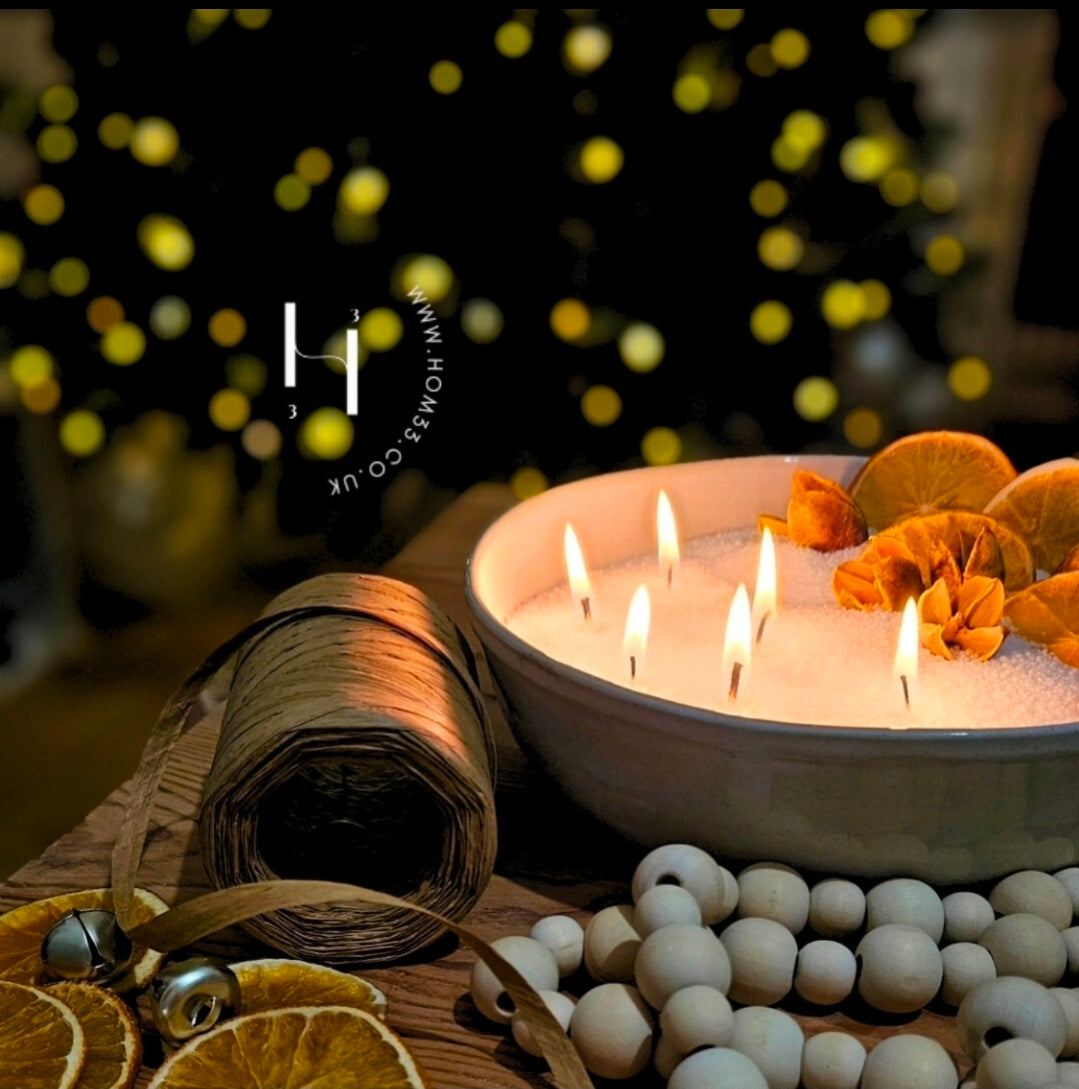 Multi-wick Christmas candle bowl with white wax pearls, dried oranges, ribbon and wooden beads.