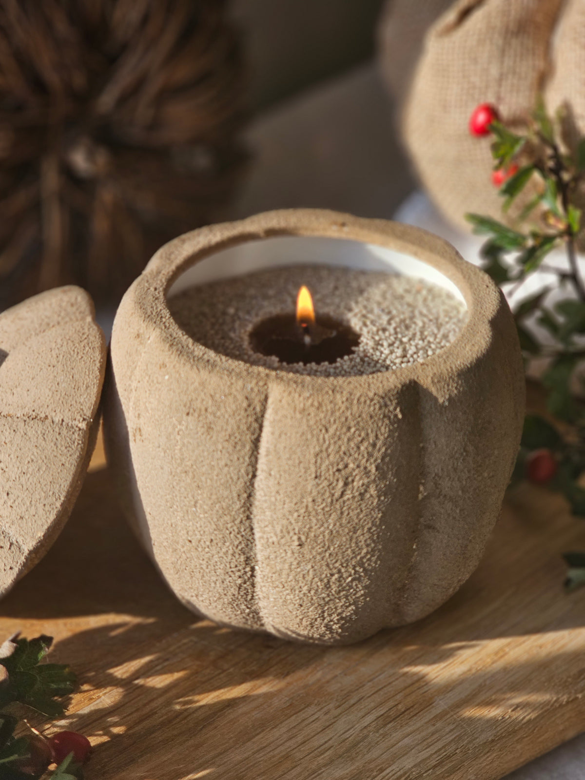Hom33 pearled candle in a textured stone pumpkin jar with a lid, styled for cosy autumn home decor.